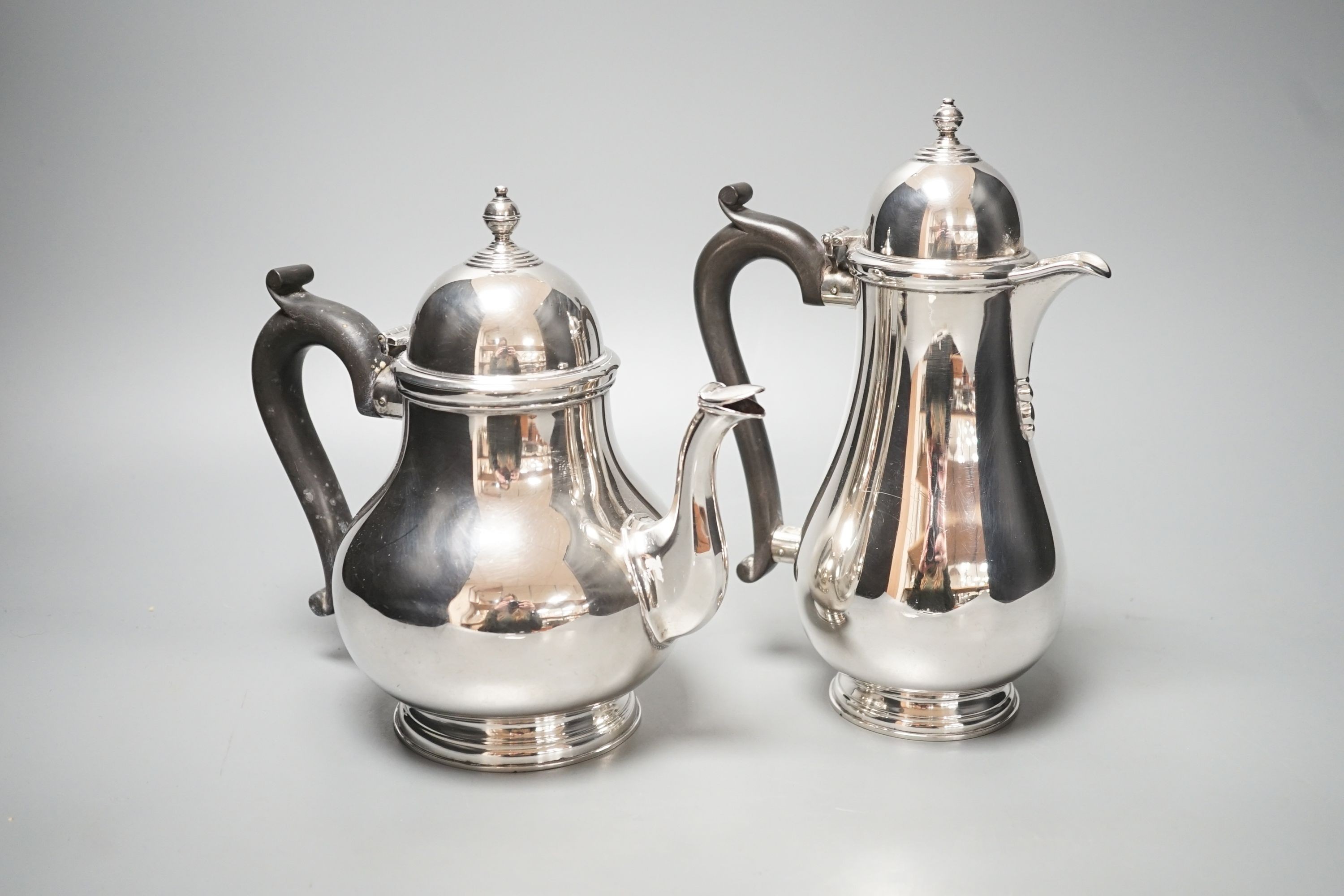 A 1930's silver coffee pot and a similar silver how water pot, Birmingham, 1934 & 1935, gross 39oz.